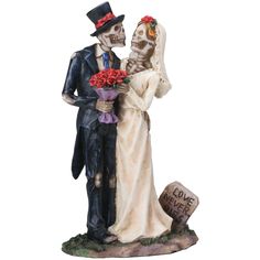 a figurine of a bride and groom holding flowers next to a tombstone with the words i love you written on it