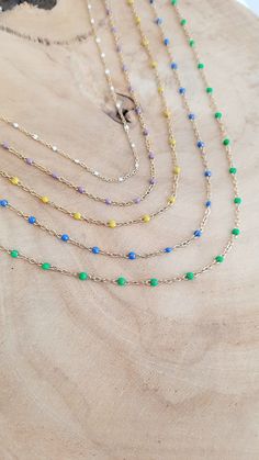 This stainless steel women's necklace consists of a fine rosary chain with epoxy resin enameled beads. 5 colors to choose from: White, Lilac, Yellow, Blue or Green An absolutely I.N.C.O.N.T.O.U.R.N.A.B.L.E necklace to adopt urgently! Wear the jewelry that suits you with Elle&Co Bijoux https://elleandcobijoux.etsy.com FEATURES : Entirely handmade jewelry. Gold-colored stainless steel necklace, hypoallergenic. Total length of the necklace: approximately 42 cm including 4cm of extension chain (it is possible to adjust the length of the chain at your request). MANUFACTURING and CUSTOMIZATION: Each piece of jewelry is made by me in my Nîmes workshop, using carefully selected materials. These creations are produced in limited series and can be the subject of a customization request. Do not hesit Trendy Enamel Necklace With Adjustable Chain, Elegant Enamel Necklace With Adjustable Chain, Blue Stainless Steel Necklace With Adjustable Chain, Gold Enamel Necklace With Cable Chain, Rosary Chain Necklace, Blue Kyanite Gemstone Necklace, Enamel Beads, Rosary Chain, Pretty Gift