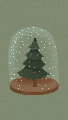 a snow globe with a christmas tree in it and snow falling down on the ground