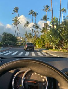 This photo is a point of view of me in the car on Kahala Ave in Kahala, Oahu, Hawaii. The clouds cover the background laced delicately on the bright blue sky. Palm trees stretch up to touch up and hills billow to the left of them covered in houses. It’s a beautiful science. Driving Car, Oahu, Hawaii, Road