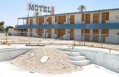 an abandoned motel is shown in the desert