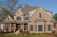 a large house with lots of windows in the front and side doors on both sides