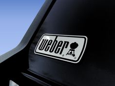 a sticker on the side of a car that says weeber with an image of a person sitting in a chair