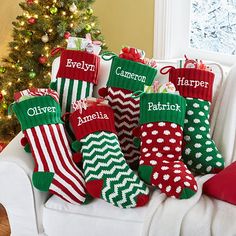 a group of christmas stockings sitting on top of a white couch