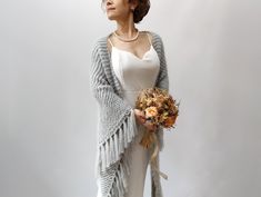 Light Gray Shawl MATERİAL: Mohair (10%) and fuzzy yarn. COLOR: Light Gray AVAİLABLE COLORS: 20 colors (See last picture) MEASUREMENTS: Length: 78'' (200cm) Width: 29'' (75cm) (without fringes) CARE INSTRUCTIONS: Hand washed or put in a delicate washing cycle of 40oC/104oF, or lower. More shawls and wraps in my shop: https://www.etsy.com/shop/Minnoshko?ref=l2-shopheader-name§ion_id=20621720 More handmade accessories and clothing in my shop: https://www.etsy.com/shop/Minnoshko?ref=l2-shop-header-a Elegant Fringed Shawl For Wedding, Elegant Fringe Shawl For Wedding, Bohemian Wedding Shawl For Winter, Bohemian Winter Wedding Shawl, Gray Shawl, Winter Wedding Shawl, Fall Winter Wedding, Ivory Bride, Fuzzy Scarf