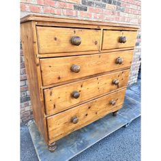 an old wooden dresser with knobs on it