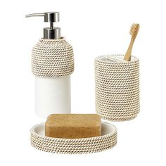 a soap dispenser and toothbrush holder with rope wrapped around it