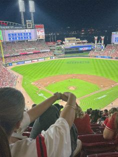 people are sitting in the stands at a baseball game, watching something on the field