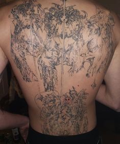 the back of a man with tattoos on his body