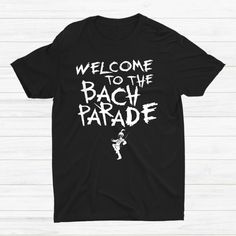 a black t - shirt that says welcome to the back parade