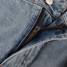 an open zipper on a pair of jeans