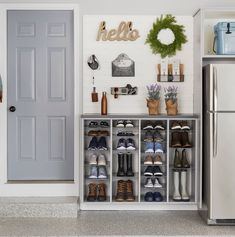 a white refrigerator freezer sitting inside of a kitchen next to a shelf filled with shoes