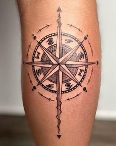 a person with a compass tattoo on their leg