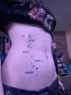 a woman's stomach with the words all of the stars have a reason written on it