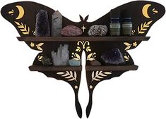 a butterfly shaped shelf with various items on it