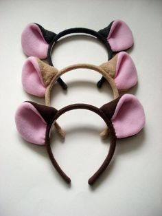 three ears are shown on top of each other, one is pink and the other is brown