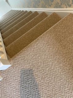 a carpeted stair case next to a staircase