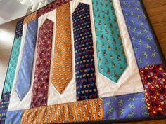 a close up of a tie quilt on a table