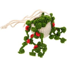 an ornament made to look like a plant with red flowers and green leaves