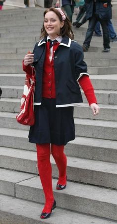 a woman in red and black is walking down some steps