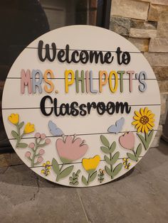 a sign that says welcome to mrs philpot's classroom with flowers and butterflies