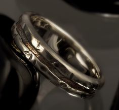 two wedding rings sitting on top of each other