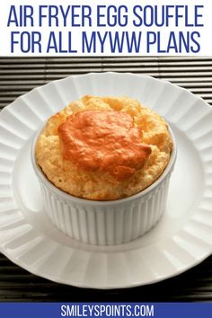 a white plate topped with a muffin on top of a table