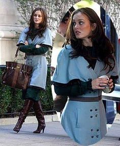 two women walking down the street with one holding a purse and another carrying a handbag