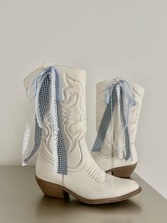 #ribbon #cowboyboots #boots #cowboy #country #bow #coastalcowgirl #cowgirl #countryconcert #inspo #aesthetic #whiteboots #trendy #blue #gingham #fashioninspo Coquette Cowgirl Boots, Bows On Cowboy Boots, Ribbon Cowboy Boots, Vintage Cowgirl Aesthetic Outfits, Cowboy Fit Aesthetic, Bows On Boots, Cowboy Boots With Ribbon, Cowboy Boots Embroidery, Ribbon On Boots