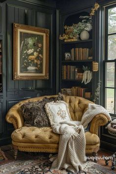 a living room filled with furniture and bookshelves next to a large painting on the wall