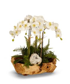 white orchids and ferns in a wooden bowl