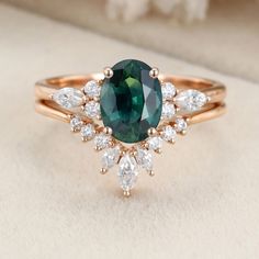 a green and white ring sitting on top of a table next to a flower arrangement