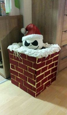 a brick chimney with a santa hat on top and eyes drawn on the bricks below