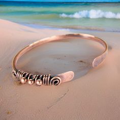 Women's bohemian copper bangle wire wrapped and antiqued to a rustic patina finish. These tribal style copper bracelets make excellent anniversary gifts. Handmade from hammered 10 gauge copper wire. These bracelets can be stacked with other bangles for a great mixed look. Stack as many as you like! This bangle is wire wrapped with 18 gauge copper wire. Makes a great gift for her! It features three wire wrap copper beads and is slightly adjustable. Copper jewelry is always a nice sentimental 7th Wire Wrap Bangle, Adjustable Bronze Bohemian Bracelets, Bohemian Electroformed Bangle Jewelry, Hand Wrapped Bronze Bohemian Bracelet, Bohemian Electroformed Bangle, Bohemian Electroformed Cuff Bracelet Bangle, Adjustable Hand Forged Bronze Bracelets, Bohemian Copper Bangle As A Gift, Bohemian Copper Bangle For Gifts