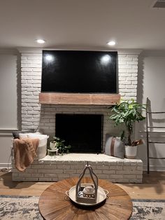 a living room with a fireplace and tv above it