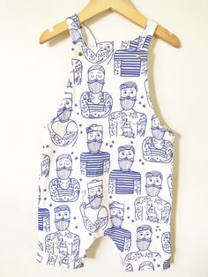 This overall romper is the perfect outfit - great in warmer weather on it's own or in cooler weather layered over a shirt. We make this one out of super soft organic cotton knit with an awesome hipster sailor print on it and include gold snaps for the fasteners. It is partially lined on the top. Diaper changes are so easy - just unsnap two snaps and pull the whole thing down. Much easier than snaps at the inseam on a squirmy baby! F A B R I C This romper features 100% organic cotton knit fabric Cotton Jumpsuits And Rompers With Pockets For Playwear, White Printed Jumpsuits And Rompers For Playwear, Summer Cotton Printed Bubble Romper, Summer Cotton Overalls For Playwear, Printed Cotton Onesie For Playwear, Cute Bib Front Overalls For Summer, White Cotton Bib Front Jumpsuit, Cotton Shortalls For Playwear In Spring, Unisex Organic Cotton Onesie For Summer