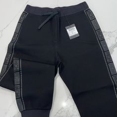 Mcm Straight Pants, Color: Black, They Are Perfect For A Casual Sporty Look, They Go As Straight Pants But In The Bottom They Look Like Joggers As You Can Tell In The Pictures. Casual Black Bottoms With Logo Waistband, Casual Black Pants With Logo Waistband, Black Athleisure Pants With Logo Waistband, Black Athleisure Bottoms With Tapered Leg, Luxury Straight Pants Bottoms With Pockets, Black Tapered Leg Athleisure Bottoms, Black Straight Leg Pants With Elastic Side Panels, Black Tapered Leg Sweatpants, Black Straight Pants With Elastic Side Panels