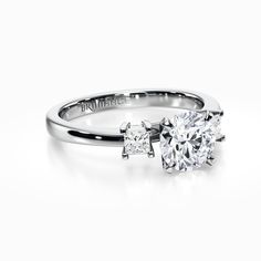 a diamond engagement ring with two diamonds on the side and an inscription that reads,'i