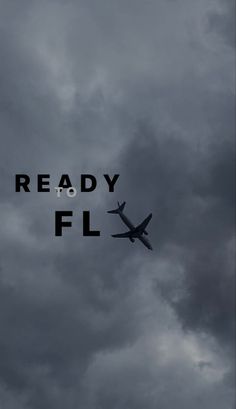 the words ready to fly are in front of an airplane flying high up in the sky