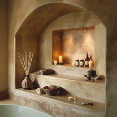 a bath room with a tub and candles