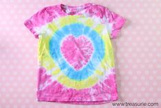 a pink, blue and yellow tie - dye shirt with a heart on it