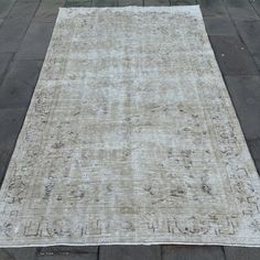 an old rug is laying on the sidewalk