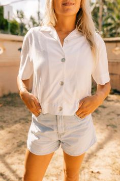 The ultimate white shirt. Besides the fact that this shirt is made from upcycled material, it is the one item you MUST own in your closet. The most versatile item, a core staple piece. Made for the modern women, this is the new white button down shirt, no basic here. Pay close attention to the repurposed shell buttons, that add that extra touch. Wear buttoned up with your favorite pair of denim or try unbuttoning it over a tank or dress for a layered look. Our Camp Shirt fits loosely in the body Shirt Photography, T-shirt Photography, Camp Shirts, White Button Down Shirt, Camping Outfits, Camp Shirt, White Button Down, White Solid, Shirt Fits