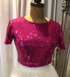 Wedding Sequin top Cerise pink, bridal or bridesmaid top. Sequin covered cropped bridal top with short sleeves. This item has a high front and back neckline,it is a cropped length to sit just above the natural waistline, but can be made to any desired length. This top is made from sequin stretch fabric and lined with a soft ivory jersey fabric. This top is made to be quite fitted but if you desire a loser fit just let me know.    If you require this top in any other colours or different fabric p Elegant Short Sleeve Party Crop Top, Elegant Short Sleeve Crop Top For Party, Short Sleeve Sequin Crop Top For Party, Summer Wedding Crop Top, Pink Short Sleeve Blouse For Party, Elegant Cropped Crop Top For Wedding, Elegant Pink Cropped Top, Elegant Pink Evening Crop Top, Elegant Pink Crop Top For Evening