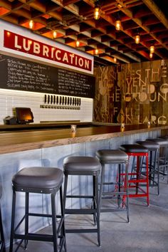 several stools are lined up in front of the bar at lubrication restaurant