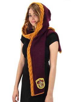 a woman wearing a harry potter scarf with hogwart's crest on the side