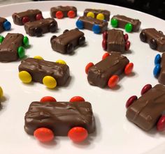 a white plate topped with chocolate cars and candy