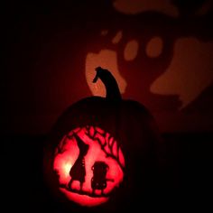 a pumpkin carved to look like a cat with its head in the shape of a dog