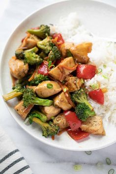 a white plate topped with rice and broccoli