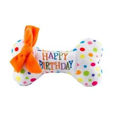 a white dog bone with an orange bow on it's head and the words happy birthday